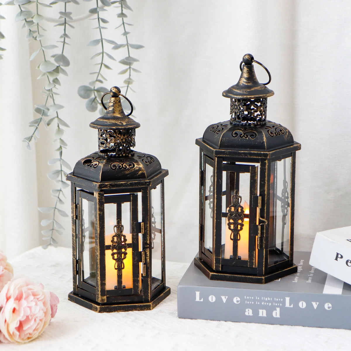 Set of two black vintage hanging lanterns with warm decorative lights